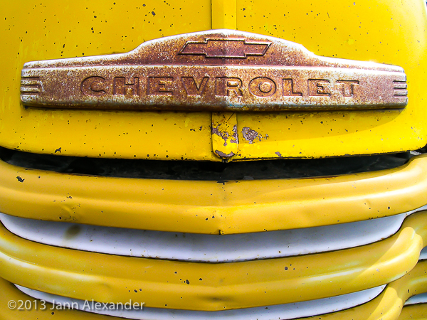 rusty-chevroley-chrome-logo-on-yellow-truck
